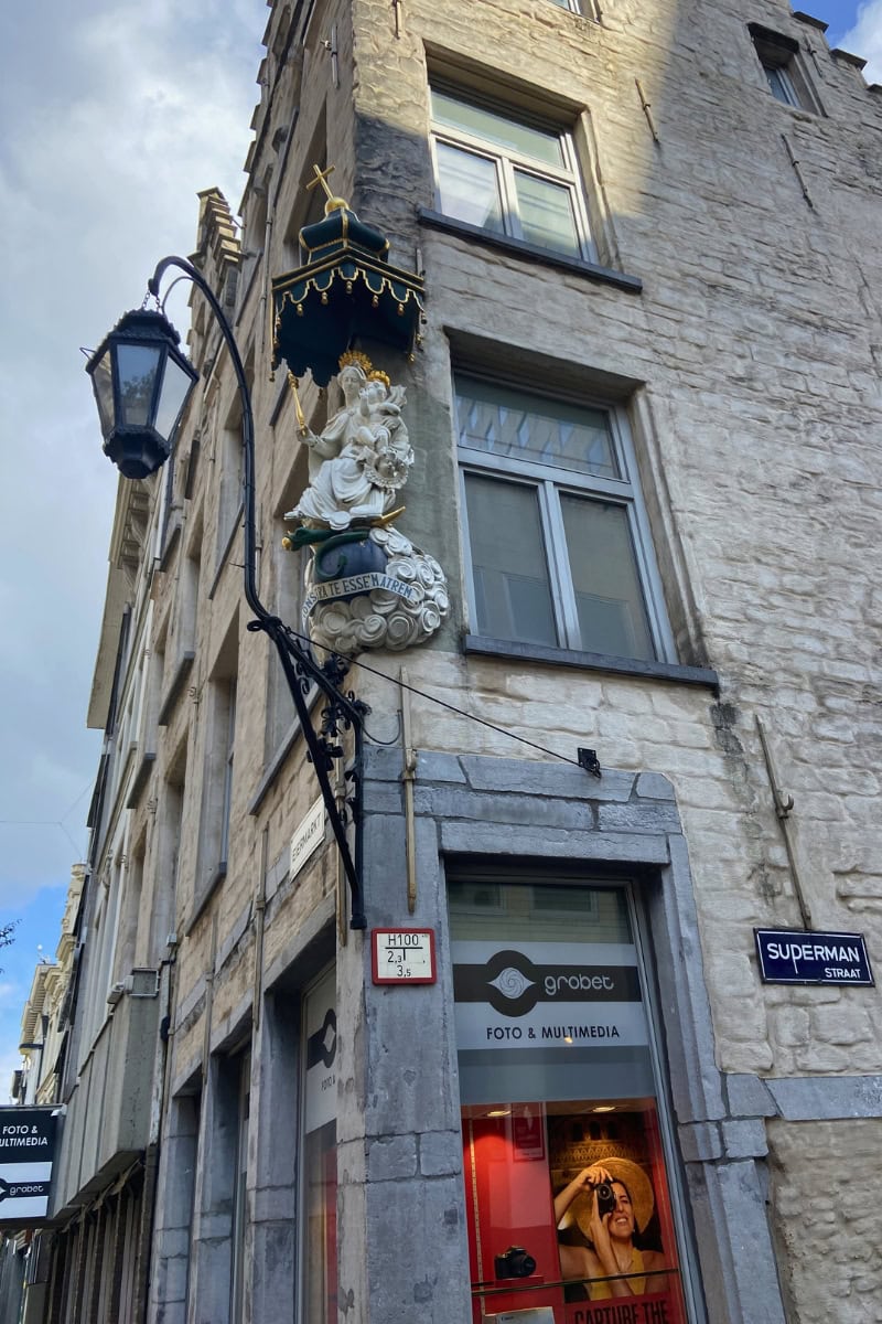 Corner statue of the Virgin Mary and Child in old town Antwerp.