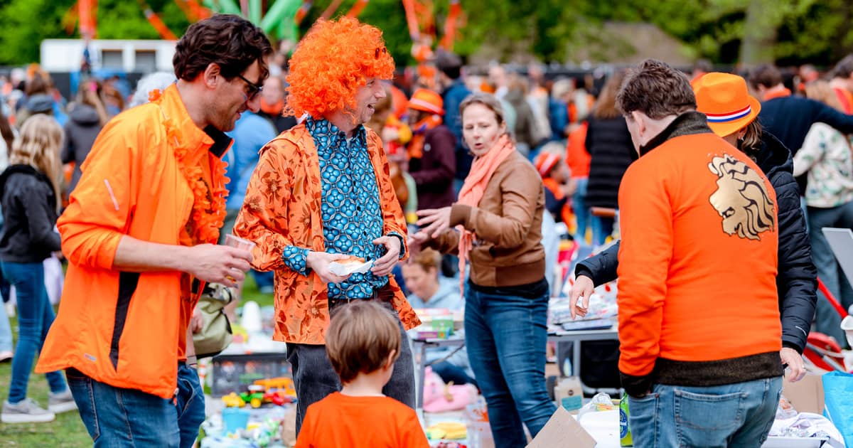 The language spoken in amsterdam is Dutch, like here at the Kings Day market.