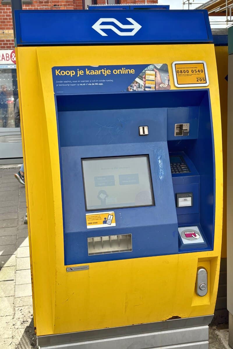 Yellow NS machine at a Dutch station selling train tickets Netherlands travellers buy on the spot