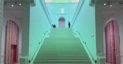 Entrance staircase in cool neon light Stedelijk Museum Amsterdam.